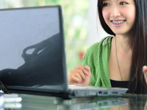 Milton Orthodontics Young Asian Girl On Computer Wearing Braces   