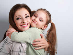 Mother with her Daughter both with confidence Daughter Invisalign Aligners can assist1